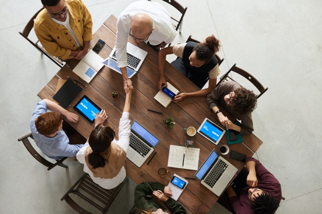 birds eye view of people having a meeting around a table
